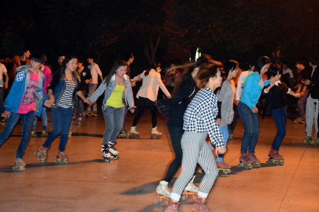 Jovens patinando na noite de Xian.