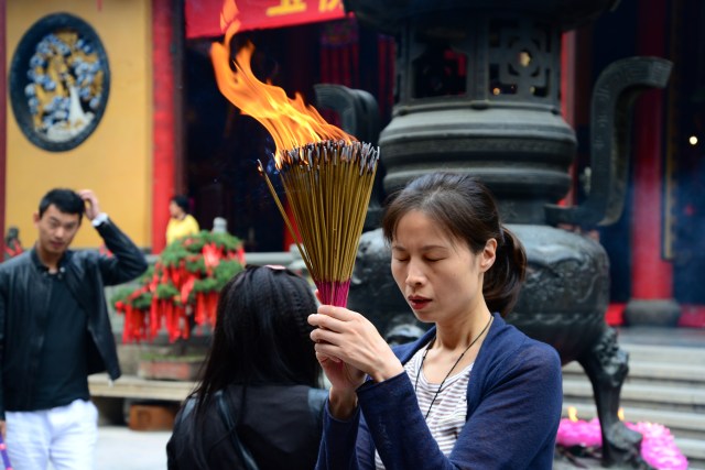 Fiel em oração no Templo Budista.